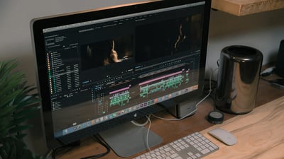 A desktop computer with editing software open. The editor is uploading royalty free music for premiere pro using the Soundstripe music extension.