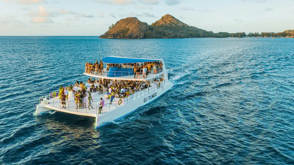  A crowd of people enjoy a yacht trip, listening to the best yacht rock songs.