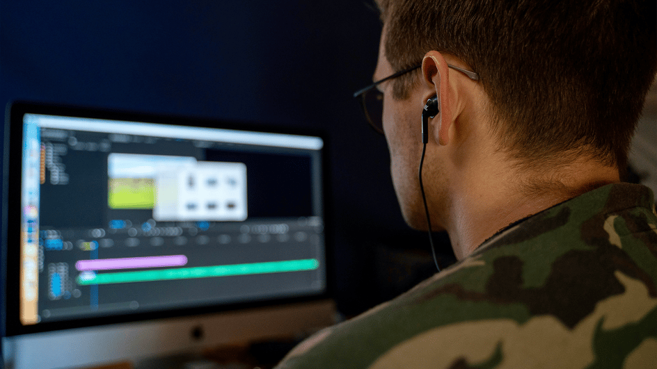  A man edits his video, taking advantage of the best AI transcription tools to make his captions.
