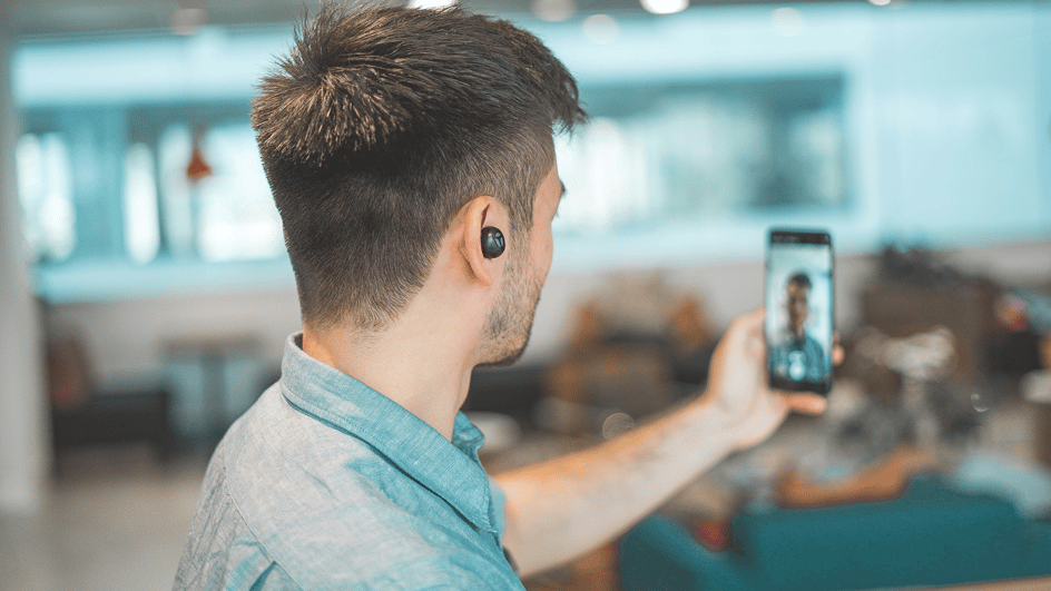  A man records a video of himself on his smartphone, wondering how to add music to CapCut when he edits the video.