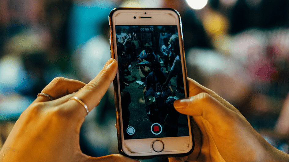  A person watches a video on their phone, wondering about how to add music to threads videos.