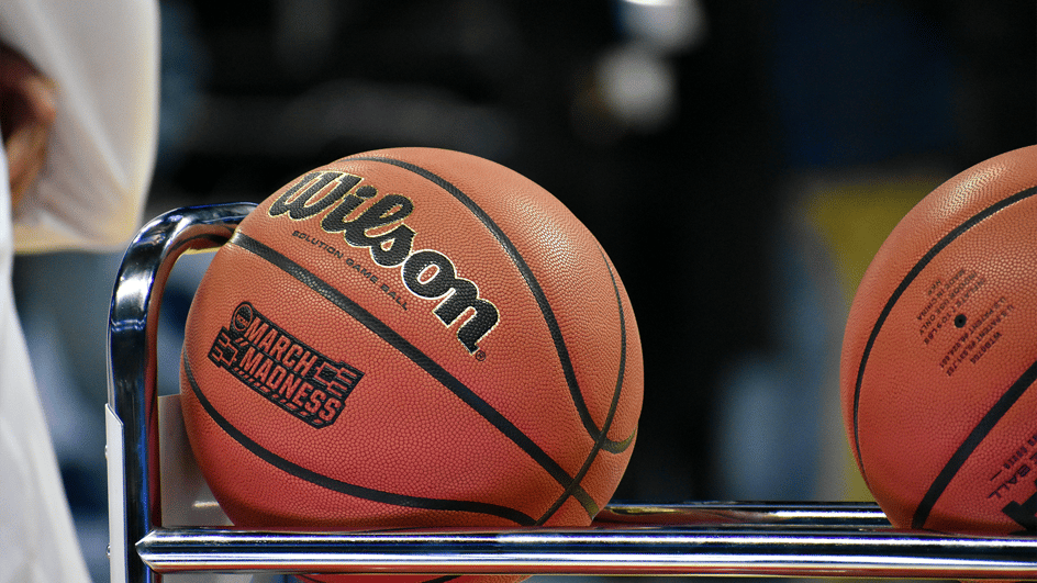  Two basketballs, embossed with ‘March Madness’ sit ready to be played in games backed by royalty free March Madness songs.