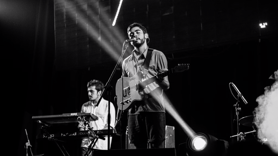  Two musicians perform on a stage, with spotlights in the foreground, as they wonder why they had their music videos removed from YouTube.